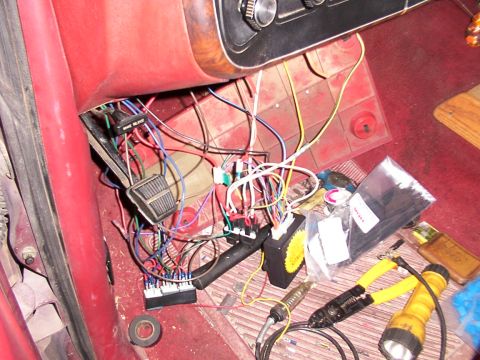 1988 Ford C-350 (Centurion Conversions) - A messy vehicle interior shows a remote start system installation with exposed wires and various tools on the floor.