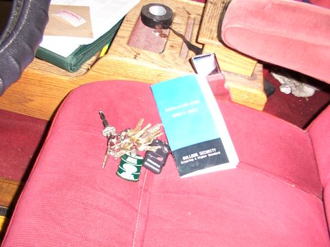 1988 Ford C-350 (Centurion Conversions) - Keys and an installation manual are on the red seat of a vehicle.