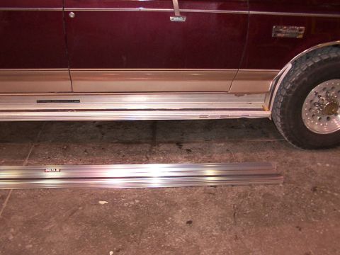 1988 Ford C-350 (Centurion Conversions) - Side view of a maroon and tan van with running boards, one of which is detached and lying on the ground.