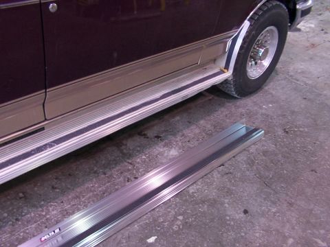 1988 Ford C-350 (Centurion Conversions) - Running boards are visible on the side of the van, with a detached running board lying on the ground in front.