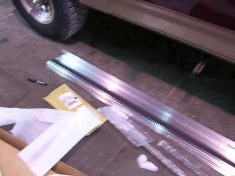 1988 Ford C-350 (Centurion Conversions) - New running boards and associated parts are laid out on the floor, ready for installation.