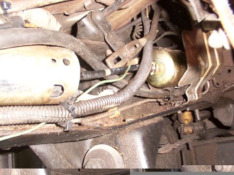 1988 Ford C-350 (Centurion Conversions) - Underside view of engine bay components, including a fuel filter and various hoses and wiring.