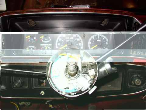 1988 Ford C-350 (Centurion Conversions) - The exposed steering column and dashboard gauges of a vehicle.