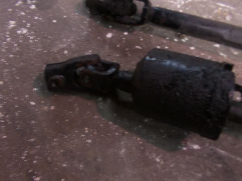 1988 Ford C-350 (Centurion Conversions) - Close-up of a steering shaft universal joint, likely removed from a vehicle for repair or replacement.