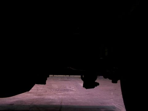 1988 Ford C-350 (Centurion Conversions) - Underside view of vehicle components, with a focus on the suspension system and tire.