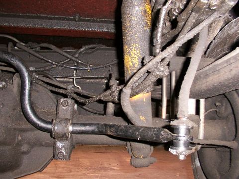 1988 Ford C-350 (Centurion Conversions) - Close-up view of a vehicle's rear sway bar link, indicating a need for replacement.