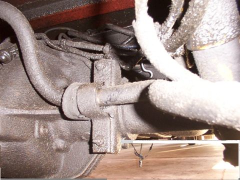 1988 Ford C-350 (Centurion Conversions) - Close-up view of a sway bar link and associated suspension parts, likely requiring replacement.