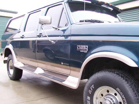 1988 Ford C-350 (Centurion Conversions) - This Ford F-Series SUV conversion features a two-tone paint scheme and prominent running boards.
