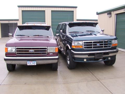 1988 Ford C-350 (Centurion Conversions) - Two trucks are parked in front of storage units.
