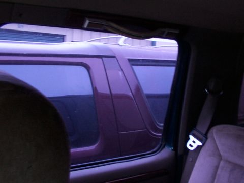 1988 Ford C-350 (Centurion Conversions) - View of a purple van's side profile from inside another vehicle.