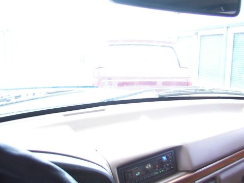 1988 Ford C-350 (Centurion Conversions) - View from inside a vehicle looking out the windshield at another red truck.