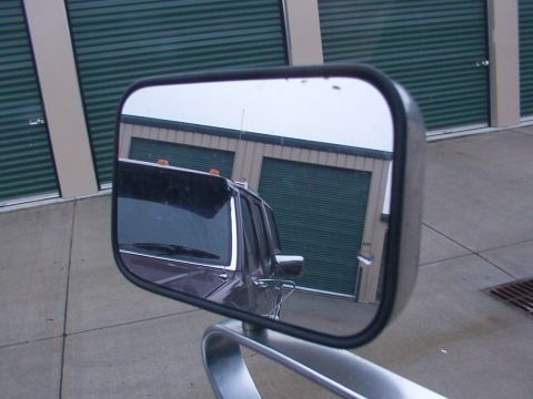 1988 Ford C-350 (Centurion Conversions) - Side mirror reflection shows the front passenger side of a 1988 Ford C-350 (Centurion Conversions) truck.
