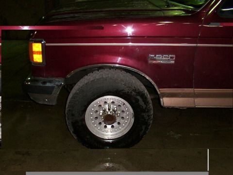 1988 Ford C-350 (Centurion Conversions) - Close-up of the front fender and wheel of a 1988 Ford F-350 Centurion Conversions truck.