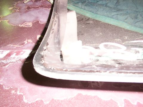 1988 Ford C-350 (Centurion Conversions) - Windshield trim and mounting bracket detail, likely from a vehicle.
