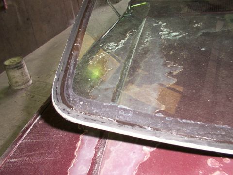 1988 Ford C-350 (Centurion Conversions) - The windshield seal is deteriorating, showing signs of wear and tear.
