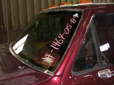1988 Ford C-350 (Centurion Conversions) - A close-up view of a truck's windshield shows pink markings with a date.