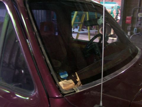 1988 Ford C-350 (Centurion Conversions) - The interior of a vehicle is visible through the windshield, with a sticker on the glass.