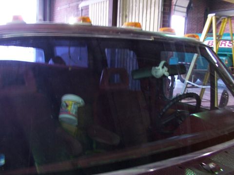 1988 Ford C-350 (Centurion Conversions) - A view into the cab of a truck, showing the interior details and amber lights on the roof.