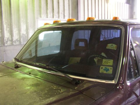 1988 Ford C-350 (Centurion Conversions) - The photo shows the front of a truck, focusing on the windshield and roofline with several amber marker lights.
