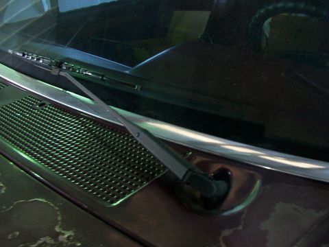 1988 Ford C-350 (Centurion Conversions) - Close-up of a vehicle's windshield wiper assembly and the textured cowl grille below it.