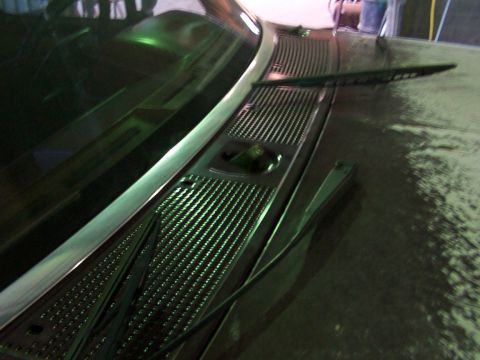 1988 Ford C-350 (Centurion Conversions) - Close-up view of a windshield wiper and the textured cowl grille on a vehicle.
