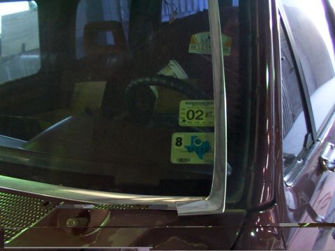 1988 Ford C-350 (Centurion Conversions) - Interior view of a vehicle's windshield with multiple registration stickers visible.