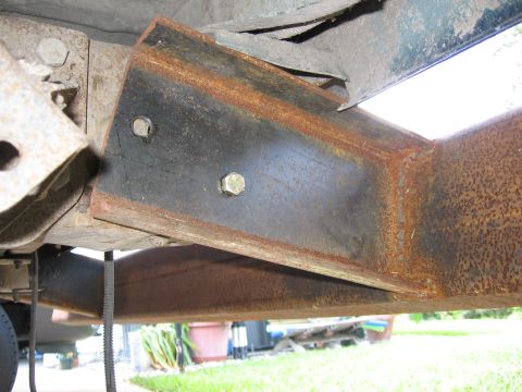 1974 Ford F-100 - Close-up view of a rusted metal bracket attached to a vehicle's frame.