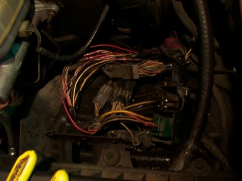 1988 Ford C-350 (Centurion Conversions) - Close-up view of a vehicle's engine compartment wiring harness and connectors.