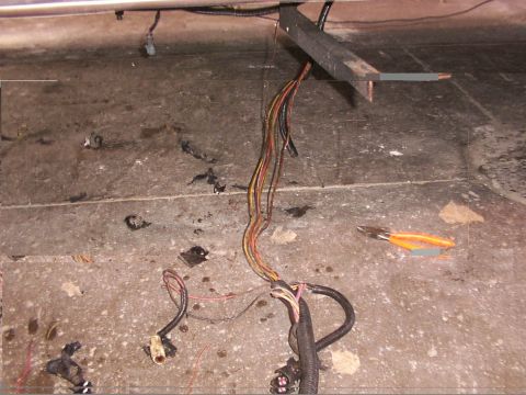 1988 Ford C-350 (Centurion Conversions) - A close-up view of a vehicle's wiring harness and a pair of wire cutters.
