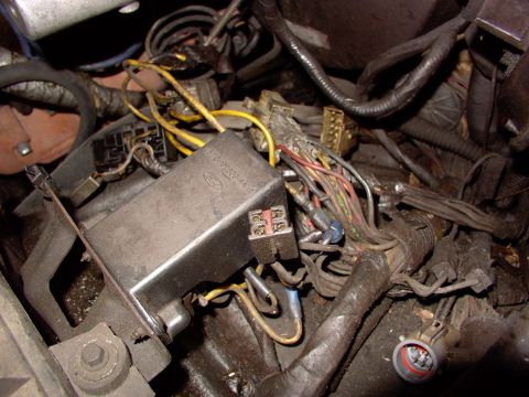 1988 Ford C-350 (Centurion Conversions) - Close-up of a vehicle's engine compartment wiring harness and electrical box.