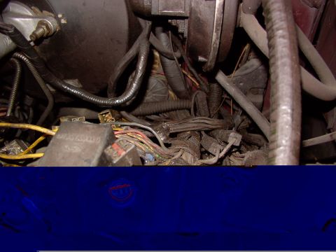 1988 Ford C-350 (Centurion Conversions) - Close-up view of a complex wiring harness and fuse box located in the engine compartment.