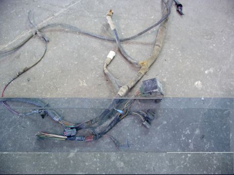 1988 Ford C-350 (Centurion Conversions) - A disassembled vehicle wiring harness with multiple connectors and wire bundles is shown on a concrete surface.