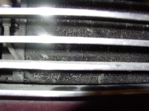 1988 Ford C-350 (Centurion Conversions) - The radiator fins are clogged with debris, indicating a need for cleaning or replacement.