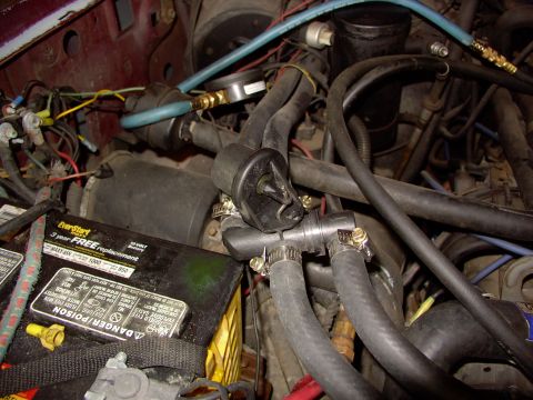 1988 Ford C-350 (Centurion Conversions) - Close-up view of engine bay components, including a battery and various hoses.