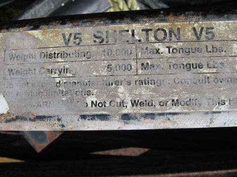 1974 Ford F-100 - A close-up view of a weathered metal plate displaying weight ratings and warnings.