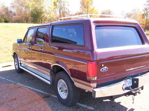 1988 Ford C-350 (Centurion Conversions) - This maroon SUV, likely a Ford Bronco, is seen from the rear quarter angle. The Ford badge is visible on the tailgate.