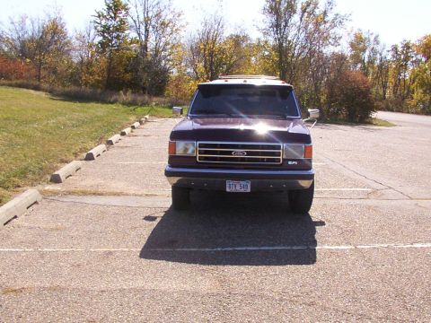 1988 Ford C-350 (Centurion Conversions) - This 1988 Ford C-350 (Centurion Conversions) is captured from a front-facing perspective in a parking lot setting.
