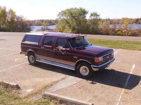 1988 Ford C-350 (Centurion Conversions) - This Ford C-350 Centurion Conversion van is parked outdoors near a body of water.