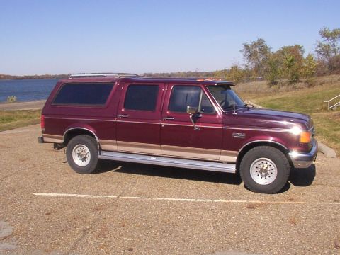 1988 Ford C-350 (Centurion Conversions) - This Ford SUV conversion, likely from the early 1990s, is parked outdoors with a body of water in the background.