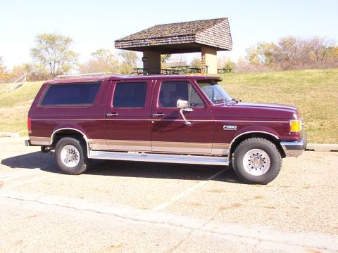 1988 Ford C-350 (Centurion Conversions) - This maroon SUV with tan trim is a Ford F-350, likely from the 1987 model year, based on its body style.