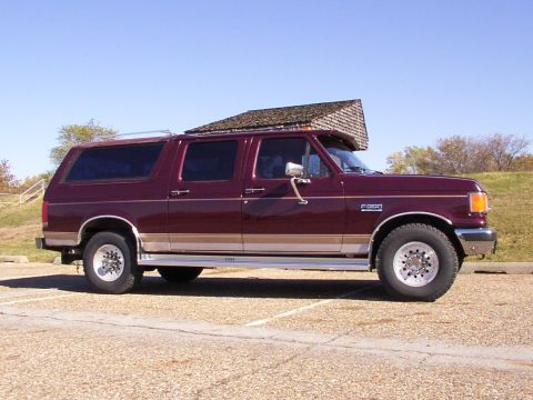 1988 Ford C-350 (Centurion Conversions) - Maroon Ford F-350 Centurion Conversion van parked outdoors on a sunny day.