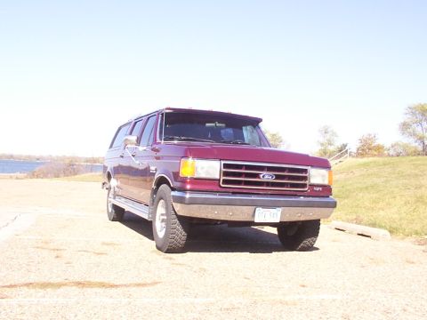 1988 Ford C-350 (Centurion Conversions) - This Ford Bronco Centurion conversion is parked outdoors on a sunny day with a lake in the background.