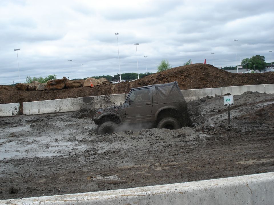 Suzuki Samurai stuck in mud, soft top, mud splattered