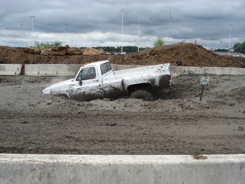 1988 Suzuki Samurai - Pickup truck stuck deep in mud during a competition.