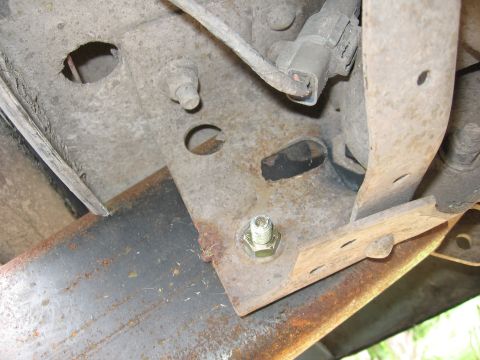 1974 Ford F-100 - Close-up view of rusted metal frame components and a bolt.
