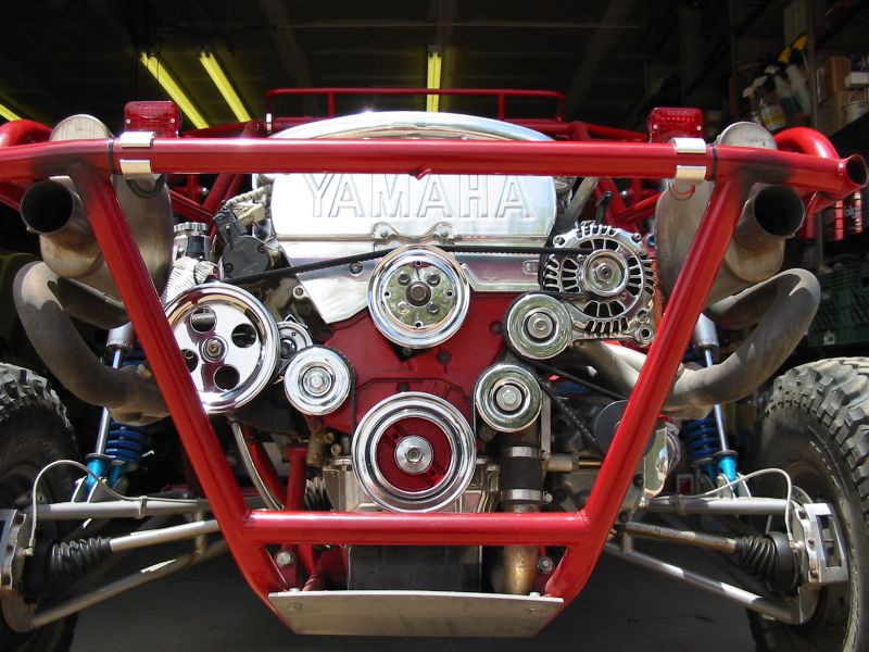 Yamaha-badged engine mounted in a red tube-frame chassis, rear view