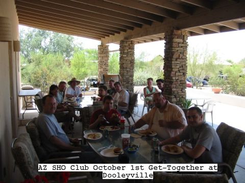 1993 Ford Taurus - Group of people seated around a patio table eating burgers under a covered porch with stone columns, captioned in white text 'AZ SHO Club O…