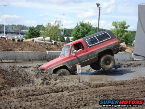 1990 Ford Bronco - Off-road vehicle attempts to navigate a challenging mud bog.
