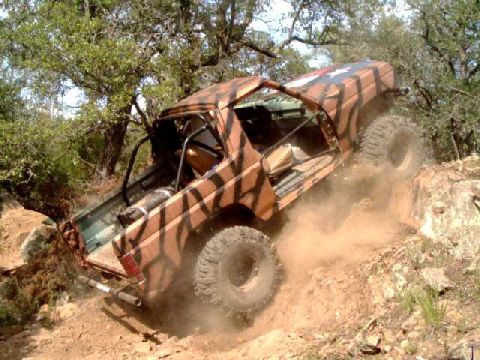 1984 Ford Bronco - Modified 1984 Ford Bronco tackling a steep, rocky incline off-road.