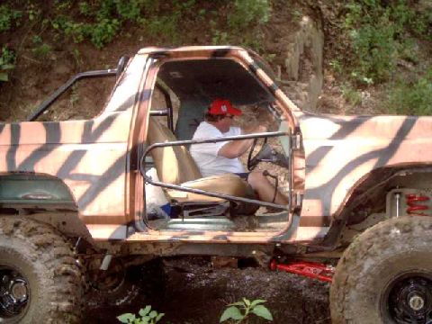 1984 Ford Bronco - This 1984 Ford Bronco is shown in a side profile, camouflage paint and modifications for off-road use.